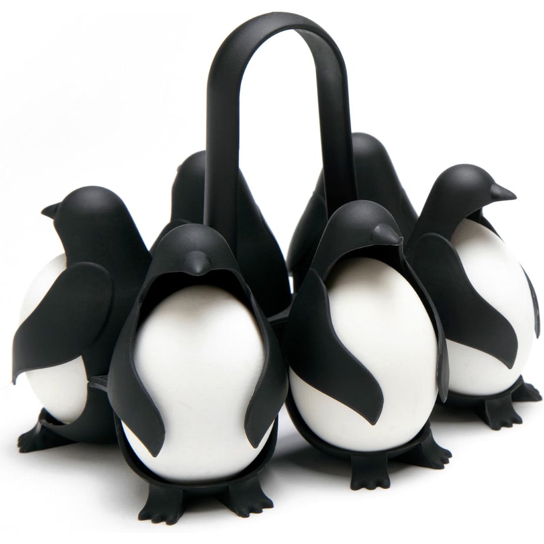 Egg cooker shaped like penguins holding eggs on a white background