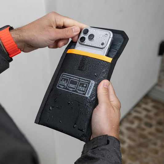 UAG x DRYOUT moisture removal phone pouch being used to dry a water-exposed smartphone