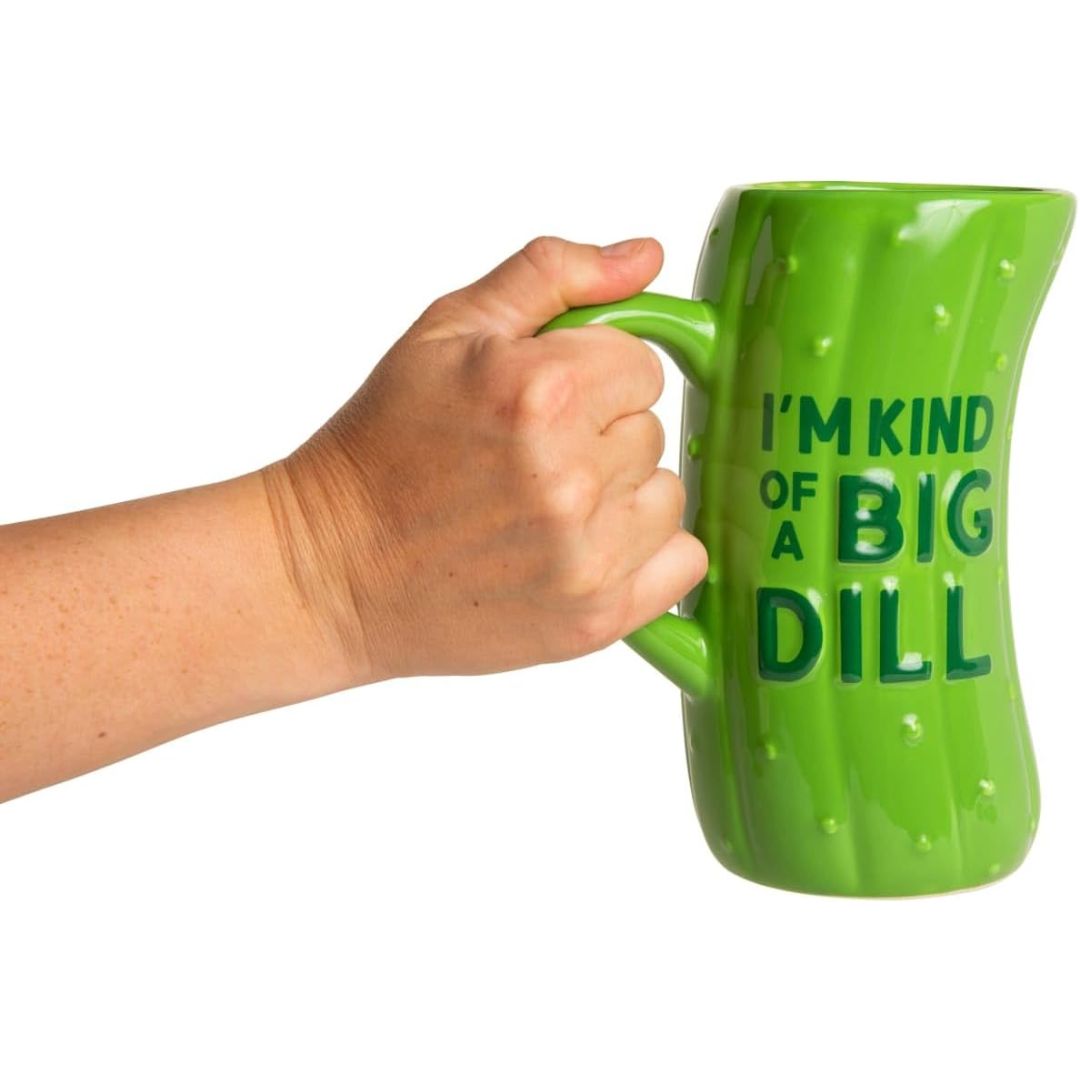 Green mug with 'I'm kind of a big dill' text held by a hand on a white background