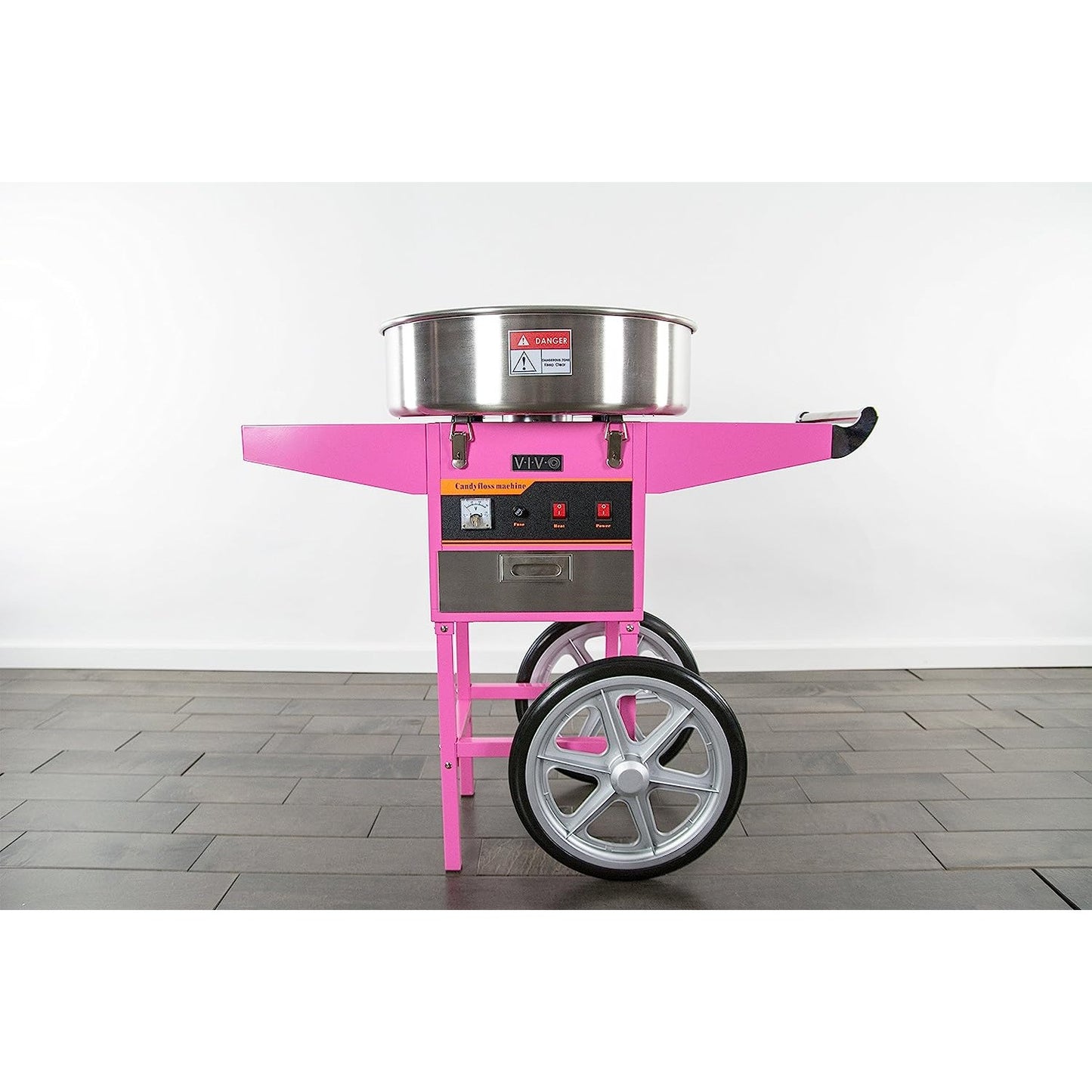 A pink cotton candy machine with cart.