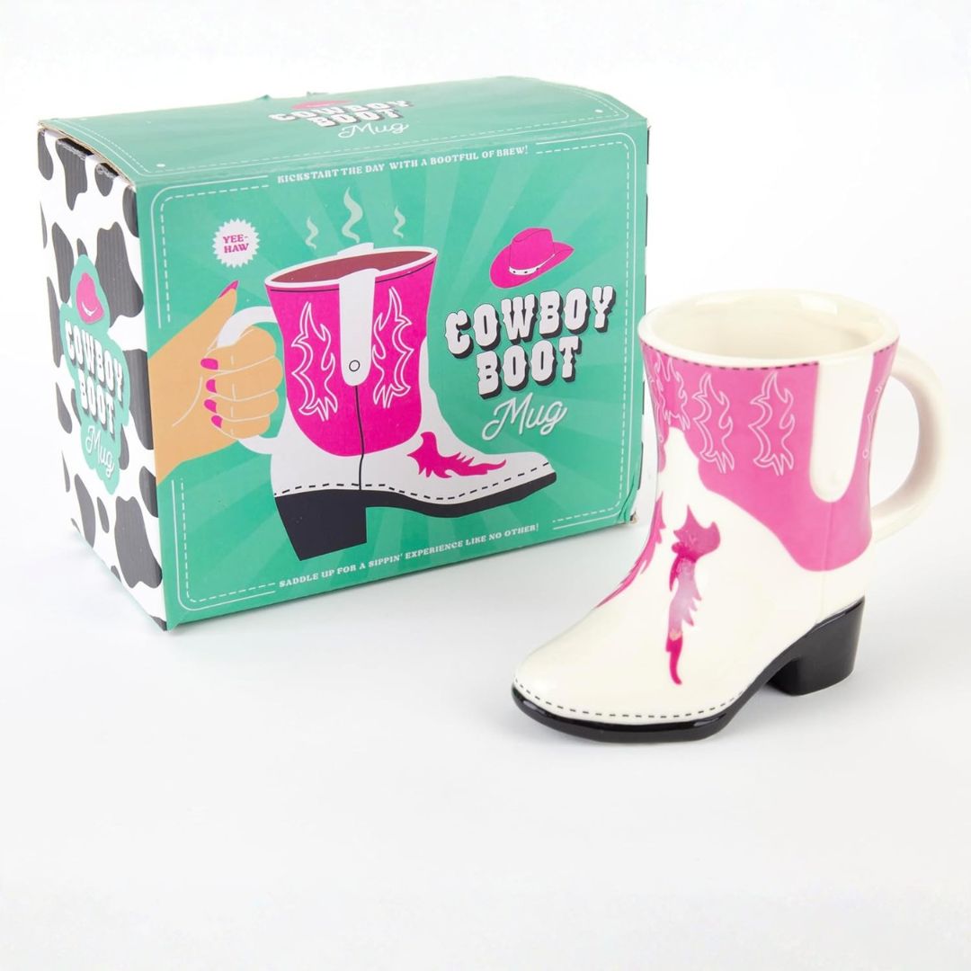 Cowboy boot mug with pink interior and white exterior, displayed with packaging on a white background.