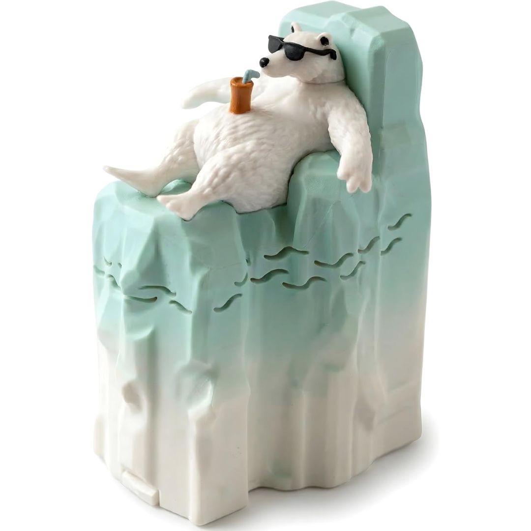 A fridge deodorizer featuring a white polar bear lounging on a light blue and white iceberg, wearing black sunglasses with a drink on his belly, set against a plain white background.