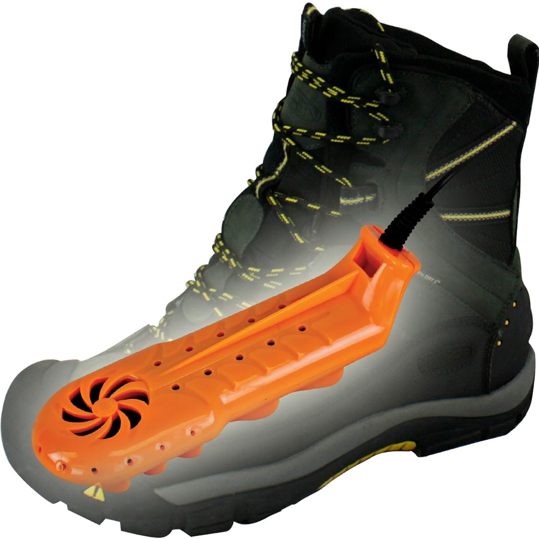 Black boot with an orange shoe dryer device inside on a white background