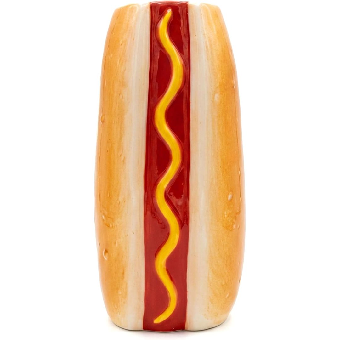 A novelty ceramic vase shaped like a hot dog in a bun, featuring a glossy red ketchup stripe with a wavy yellow mustard line down the center, set against a plain white background.
