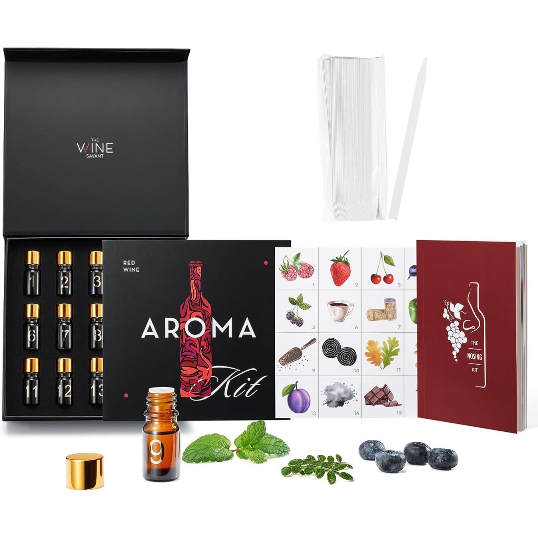 Red wine aroma training kit with scent bottles, aroma reference chart, guidebook and paper testing strips on a white background.