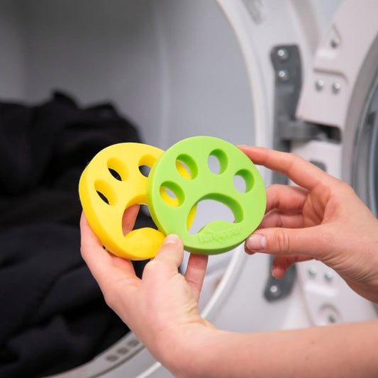 A pair of hands holding a pair of Fur Zapper's reusable laundry pet hair removers