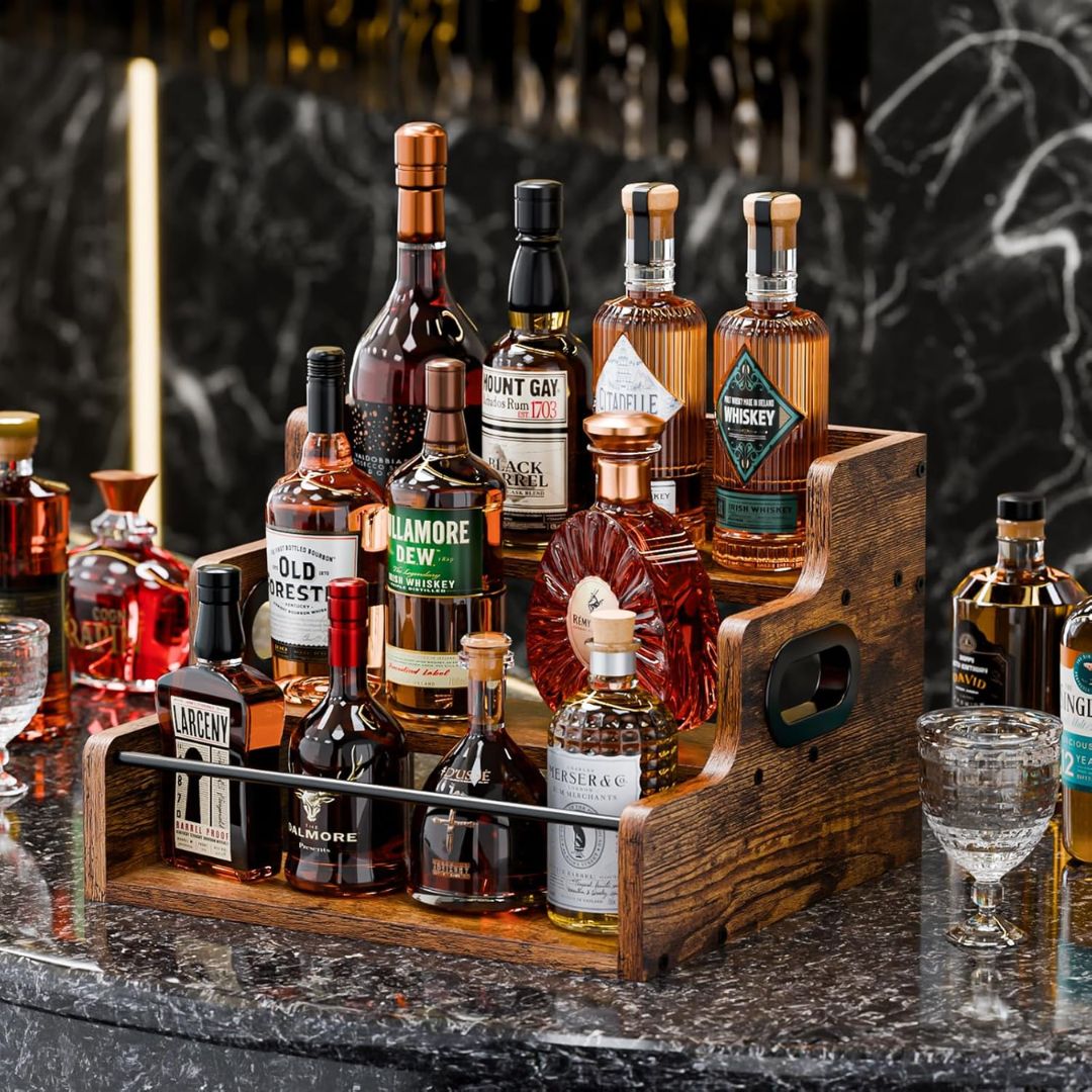 Collection of whiskey bottles displayed on a wooden display rack with a dark background.