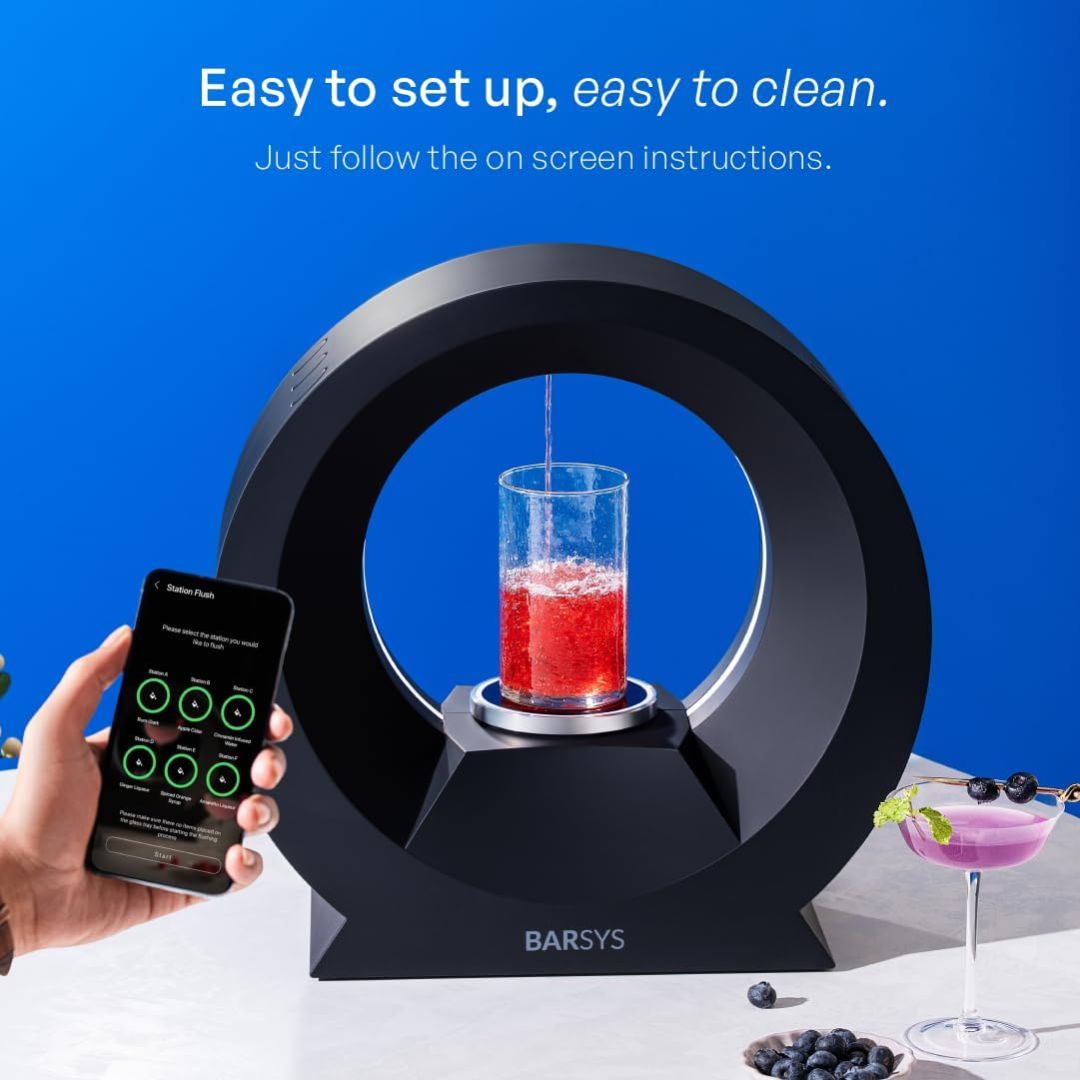Barsys smart cocktail maker with phone app controls mixing a cocktail in a glass