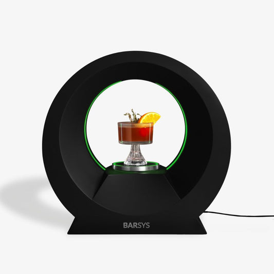 Barsys smart cocktail maker with green light ring holding a finished cocktail in a glass