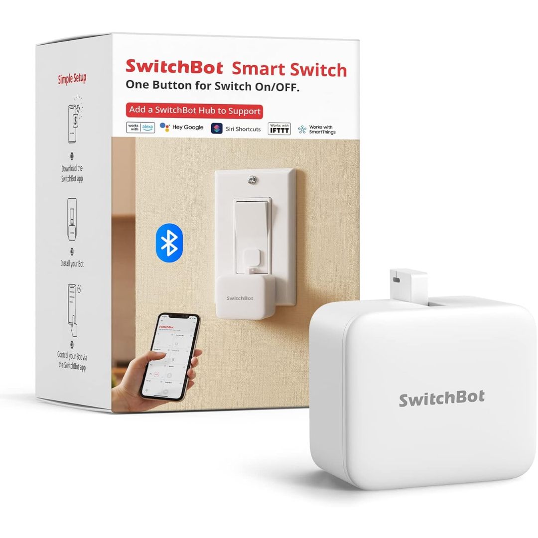 A white SwitchBot Smart Switch button pusher shown in front of its retail box on a clean white background. The packaging features red and black text, a blue Bluetooth symbol, and an illustration of a smartphone.