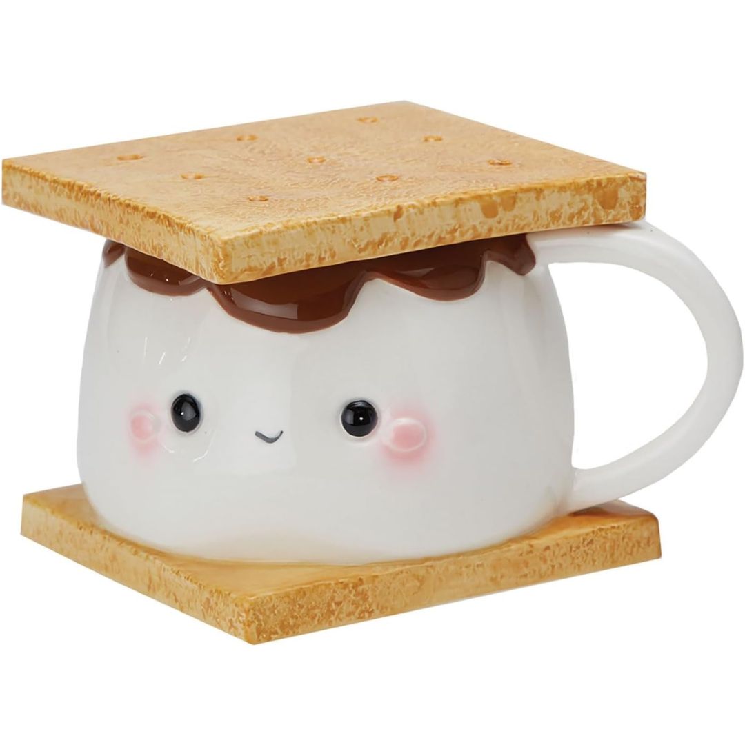 Cute mug with a face, topped with a marshmallow which looks like a s'more on a white background