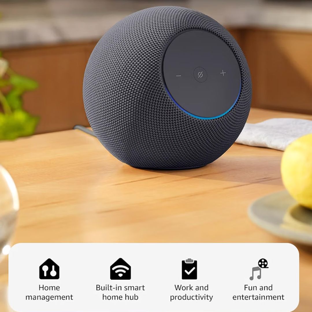 A dark gray fabric-covered spherical smart speaker sits on a wooden table in a kitchen setting, with a white informational banner at the bottom listing features like home management, built-in smart home hub, work and productivity, and fun and entertainment.