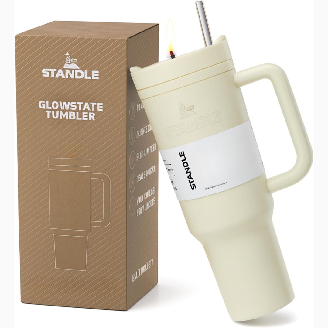 Cream-colored tumbler shaped candle with handle and straw, next to its packaging box labeled 'STANDLE Glowstate Tumbler'.