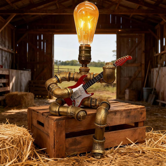 A steampunk guitar lamp holding a guitar sitting on a wooden crate in a barn.