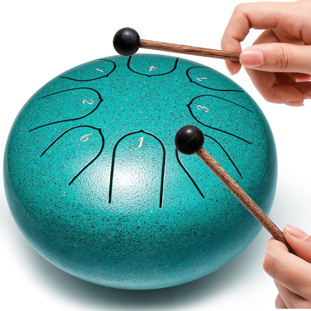 Turquoise steel tongue drum with two drum mallets on a white background