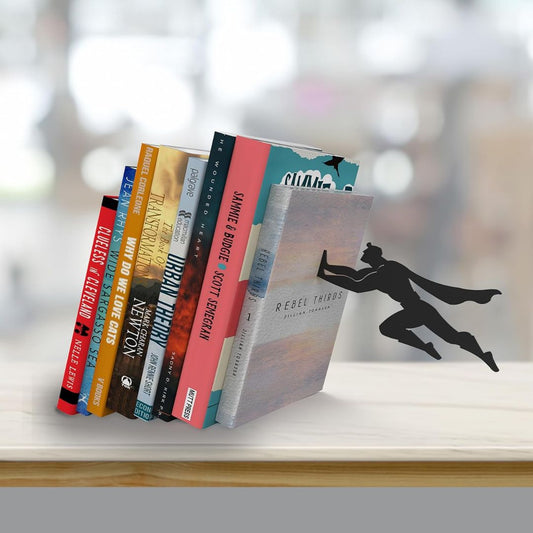 A metal superhero design bookend creating an illusion of holding up a row of books on a wooden shelf