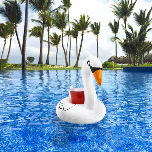 A swan shaped drink-holding pool float holding a red cup in a swimming pool.