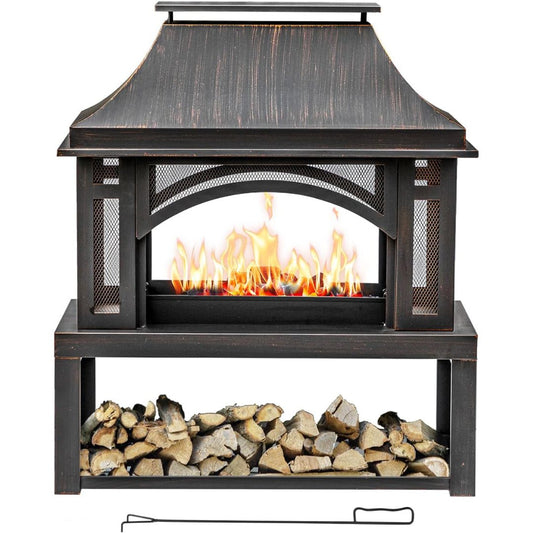 A freestanding outdoor fireplace with a dark brown/black weathered wood finish, featuring a faux flame effect in the center and a lower shelf holding stacked firewood. A metal poker is placed below the table on a white background.
