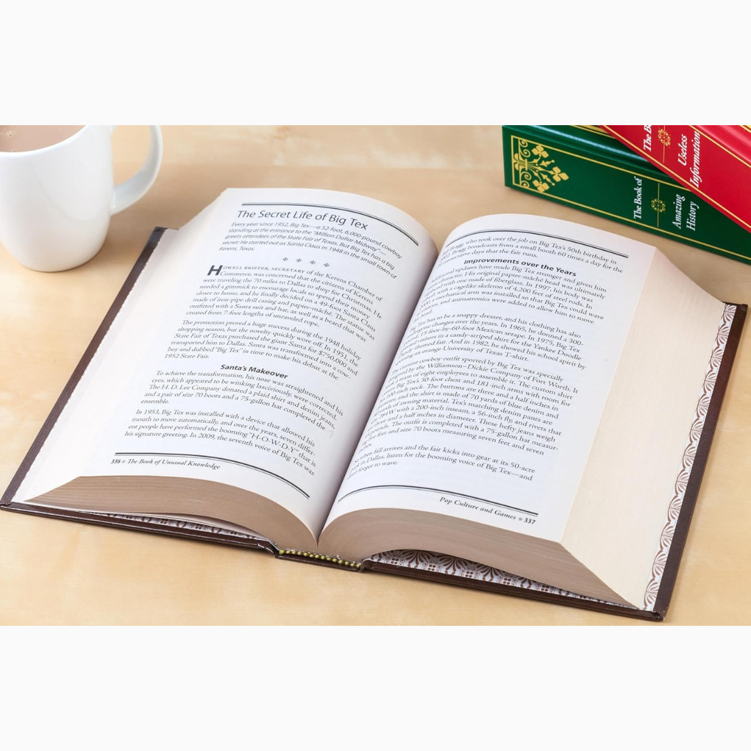 Open book on a wooden surface with a cup of coffee and a bookend.