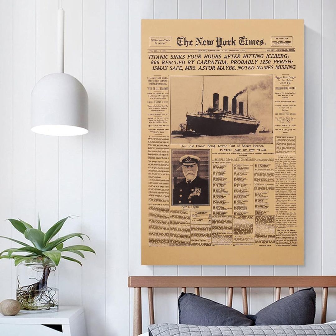 Framed newspaper with Titanic news on a wall above a bed