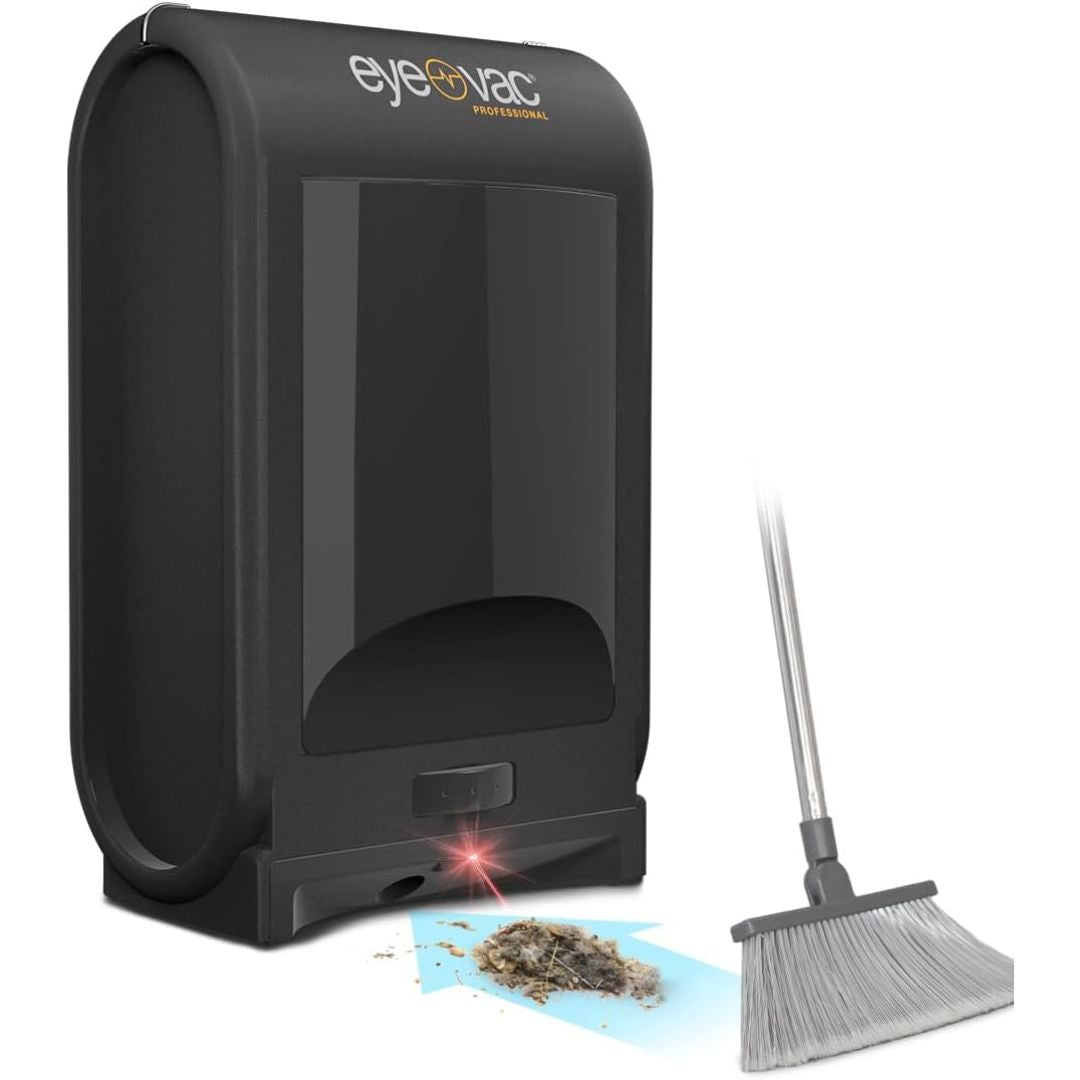 Black Eyeovac Professional automatic vacuum cleaner shown with a small pile of collected hair and a broom on a white background.
