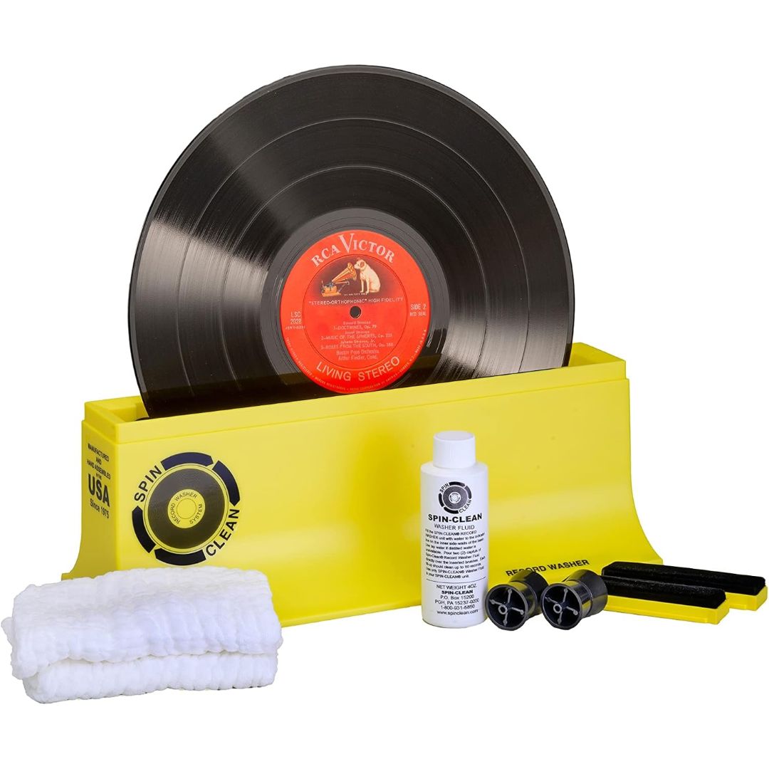 Spin-Clean vinyl record washer kit with cleaning fluid, brushes, drying cloths and an LP record in the yellow cleaning basin