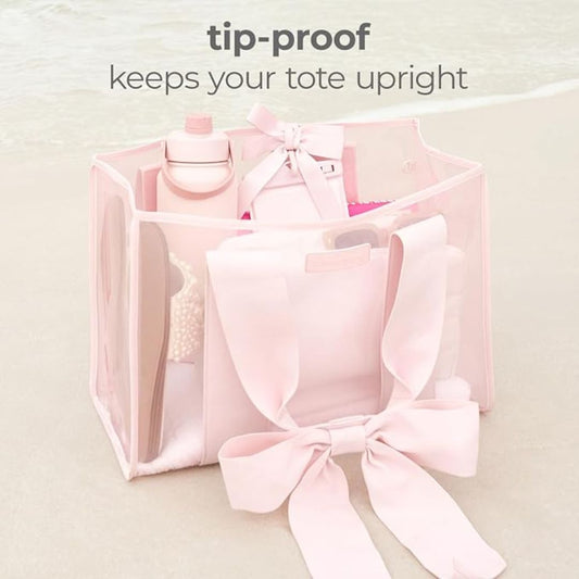 Pink structured tote bag with tip-proof design standing upright while filled with everyday essentials