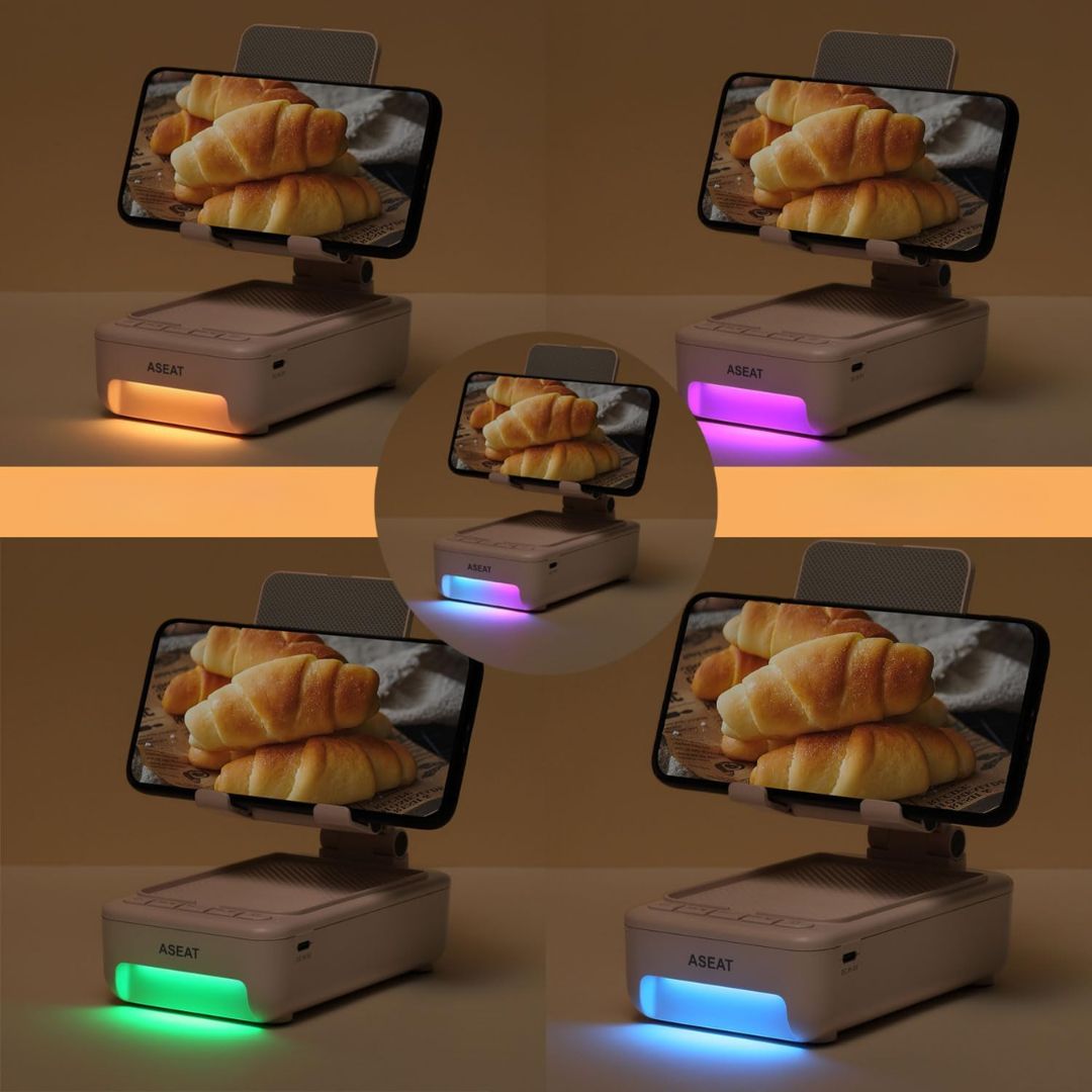 Phone display stand with phone attached showing croissants on screen, illuminated by different colors.