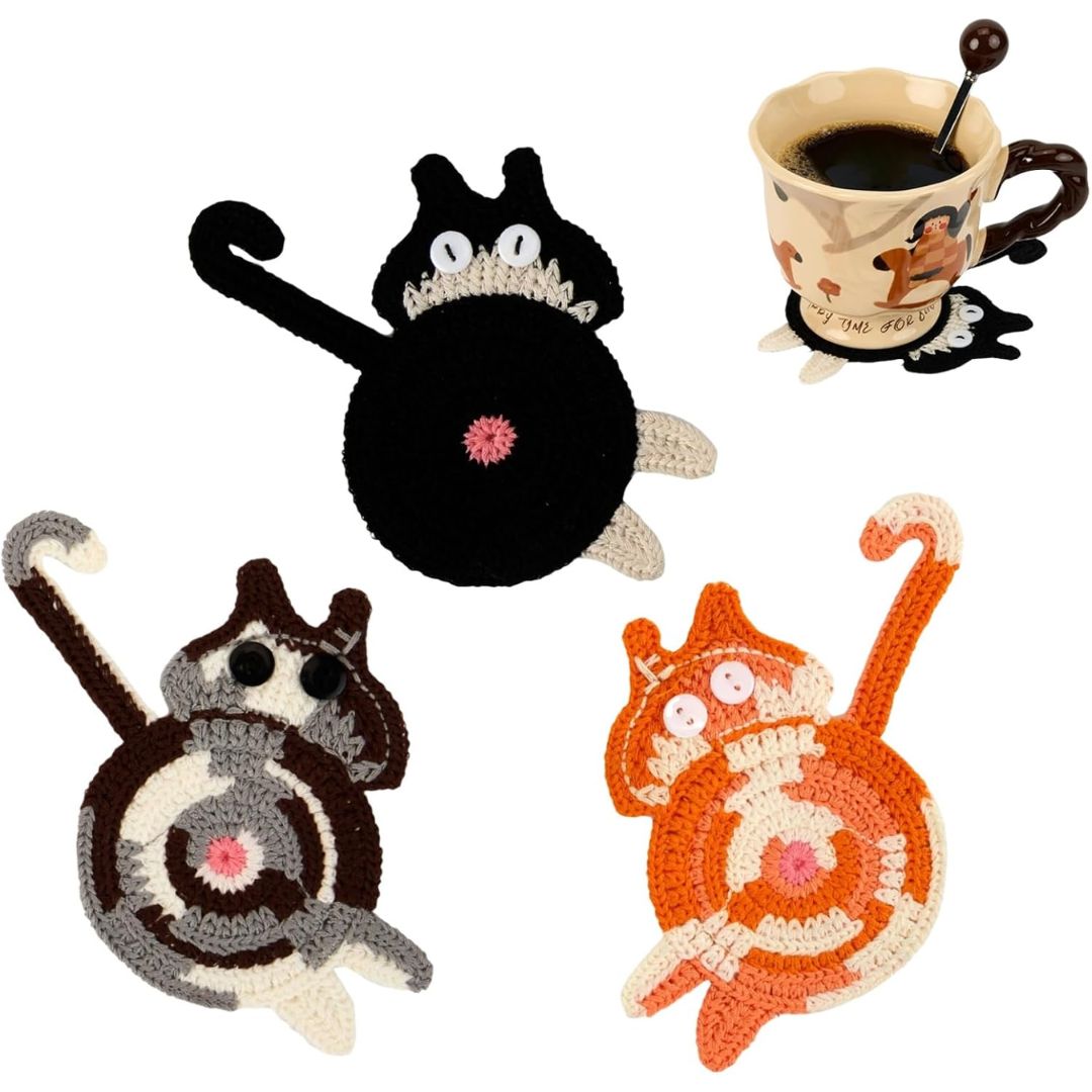 Cat-shaped coasters with a cup of coffee on a white background