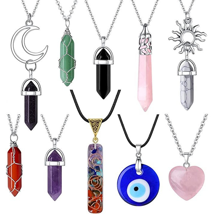 A set of 10 crystal necklaces with silver chains. Each necklace has a different colored crystal as a pendant..