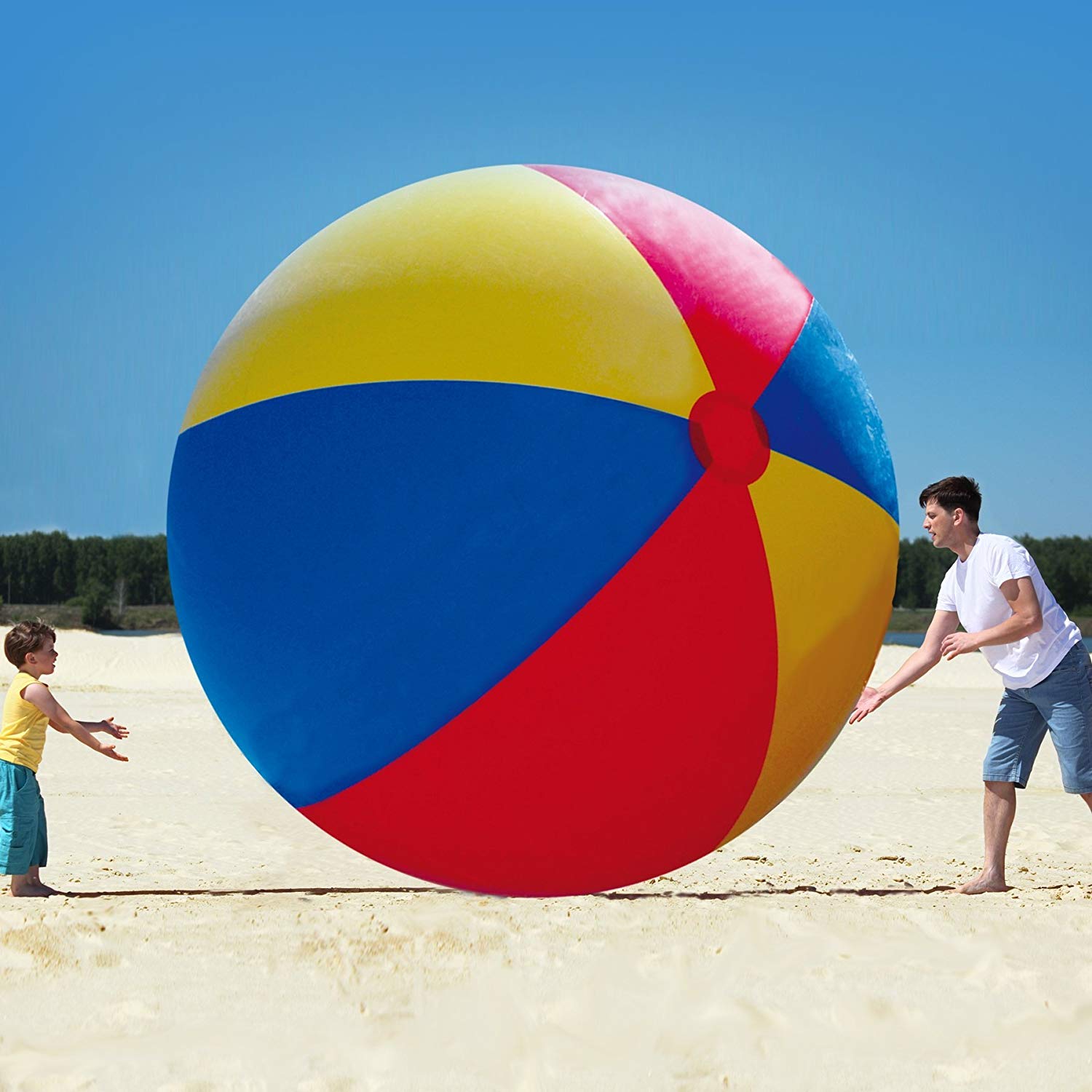 Enormous multicolored inflatable beach ball being played with outdoors