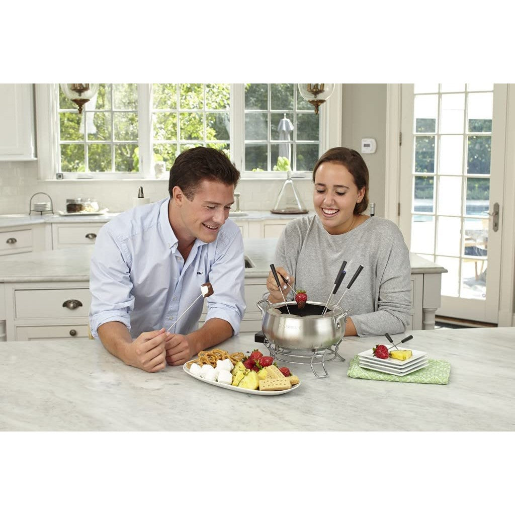 Two people are in a kitchen cooking with a 3 quart electric fondue set by Cuisinart.