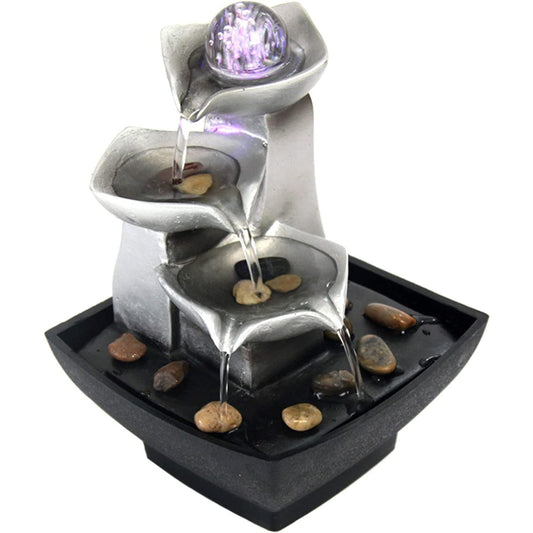 A 3-tier tabletop cascading water fountain with a spinning orb at the top and river rocks in the base.