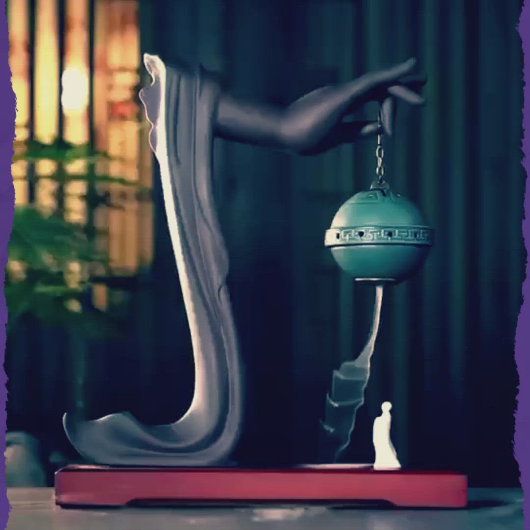 A video showing a buddha hand incense burner being used with incense coming out of the holder. 