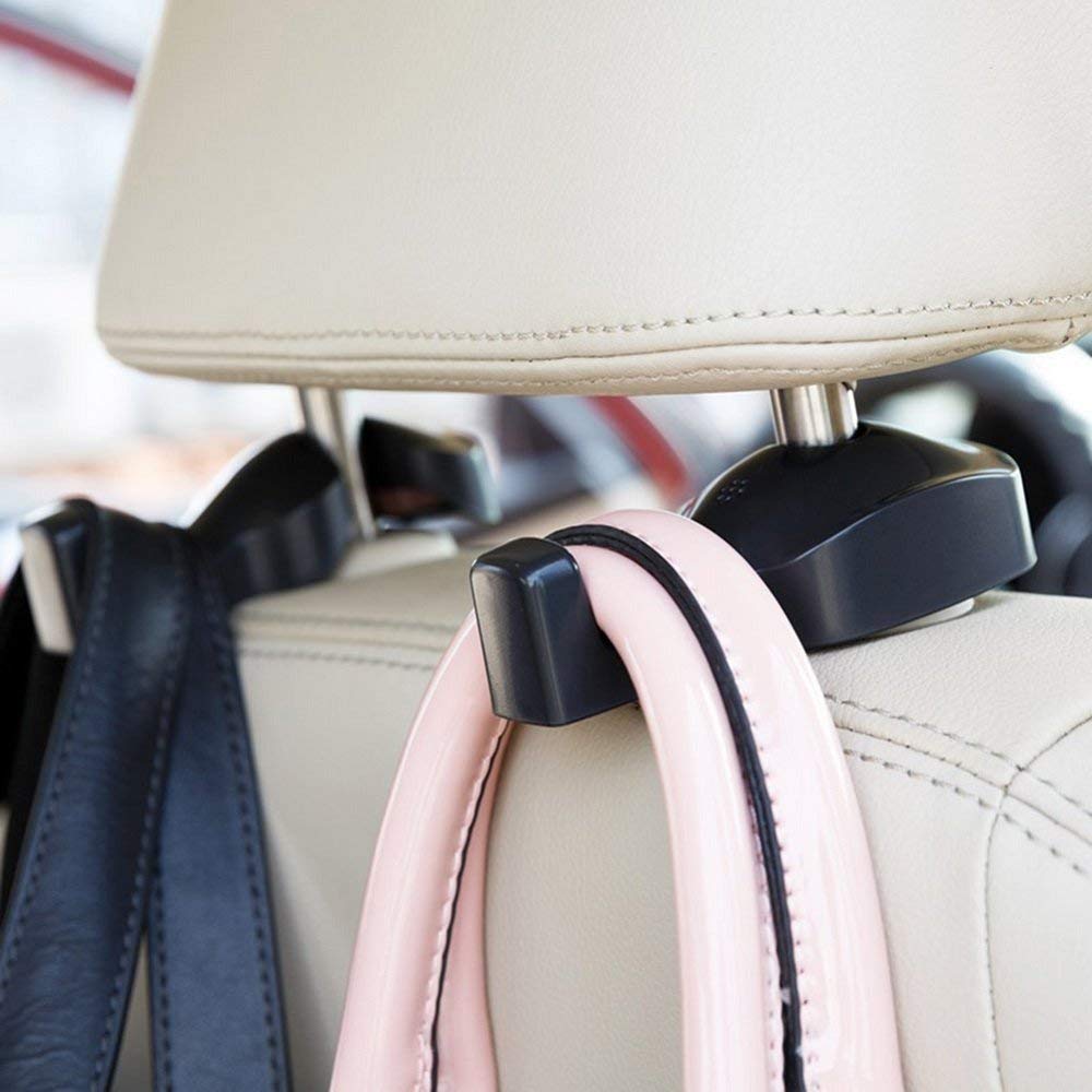 Black car headrest hooks holding handbags behind a seat