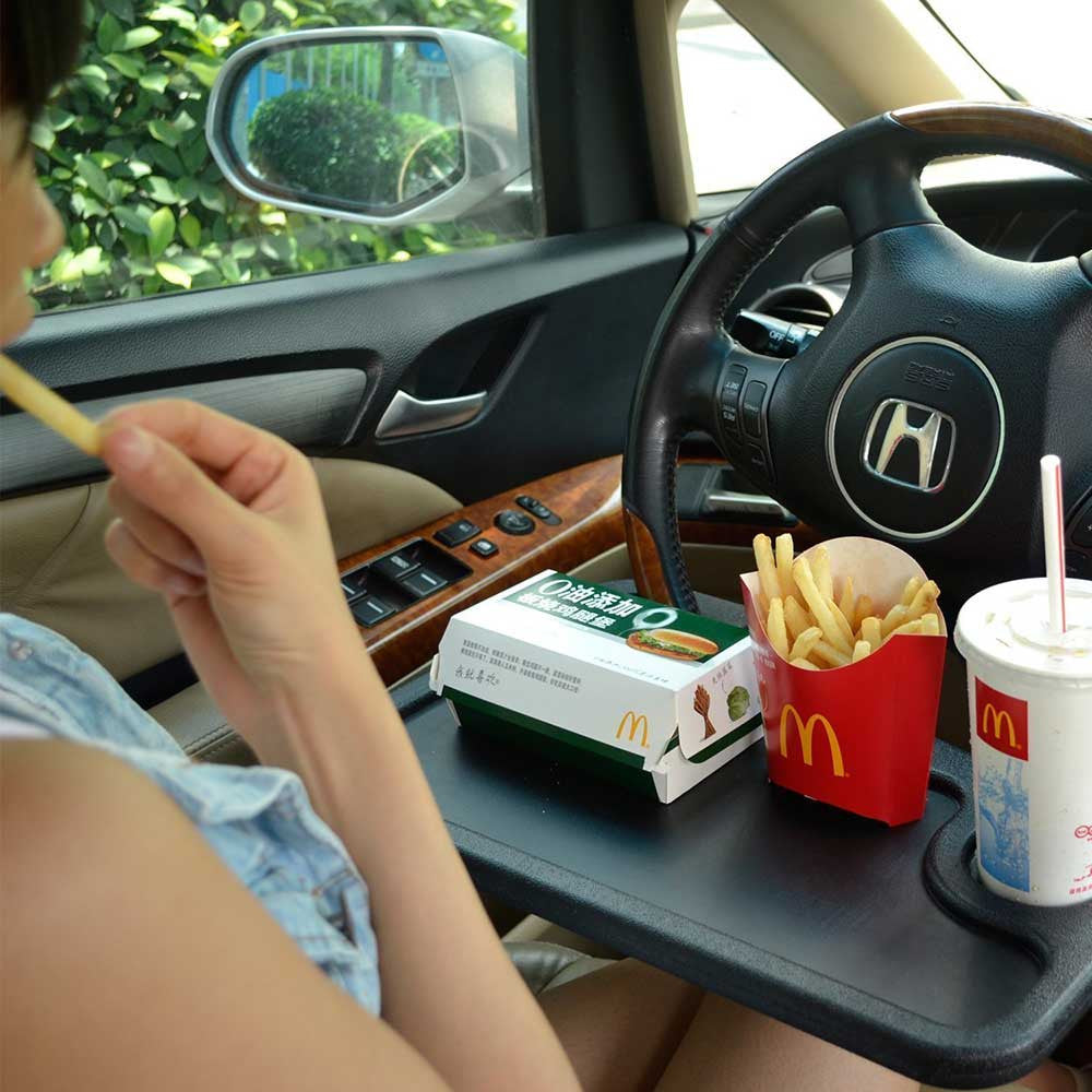 Car tray table attached to a steering wheel for eating while parked