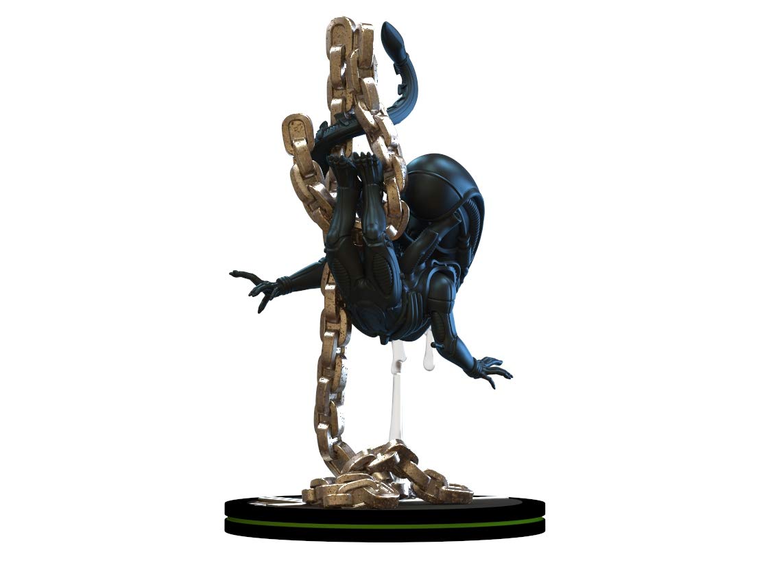 Back view of alien movie xenomorph figurine hanging off a heavy duty chain drooling slime
