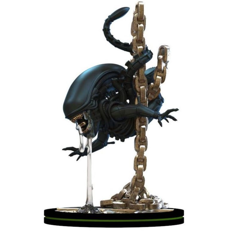 Side view of alien movie xenomorph figurine hanging off a heavy duty chain