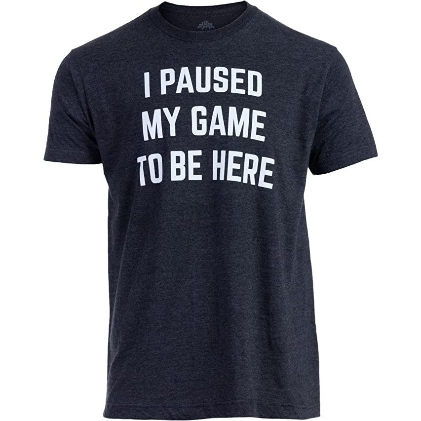 A black t-shirt with the words, 'I paused my game to be here' printed on it.