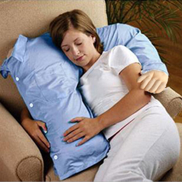 A woman is asleep on a lounge while cuddling a boyfriend pillow.