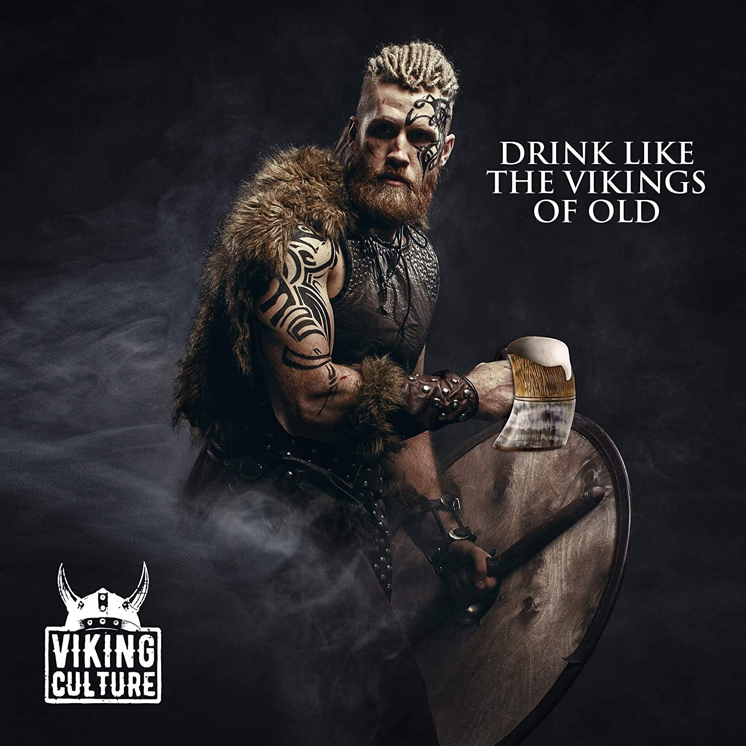 A Viking looking man holding an ox horn mug full of beer. The text reads, 'Drink like the Vikings of old.'