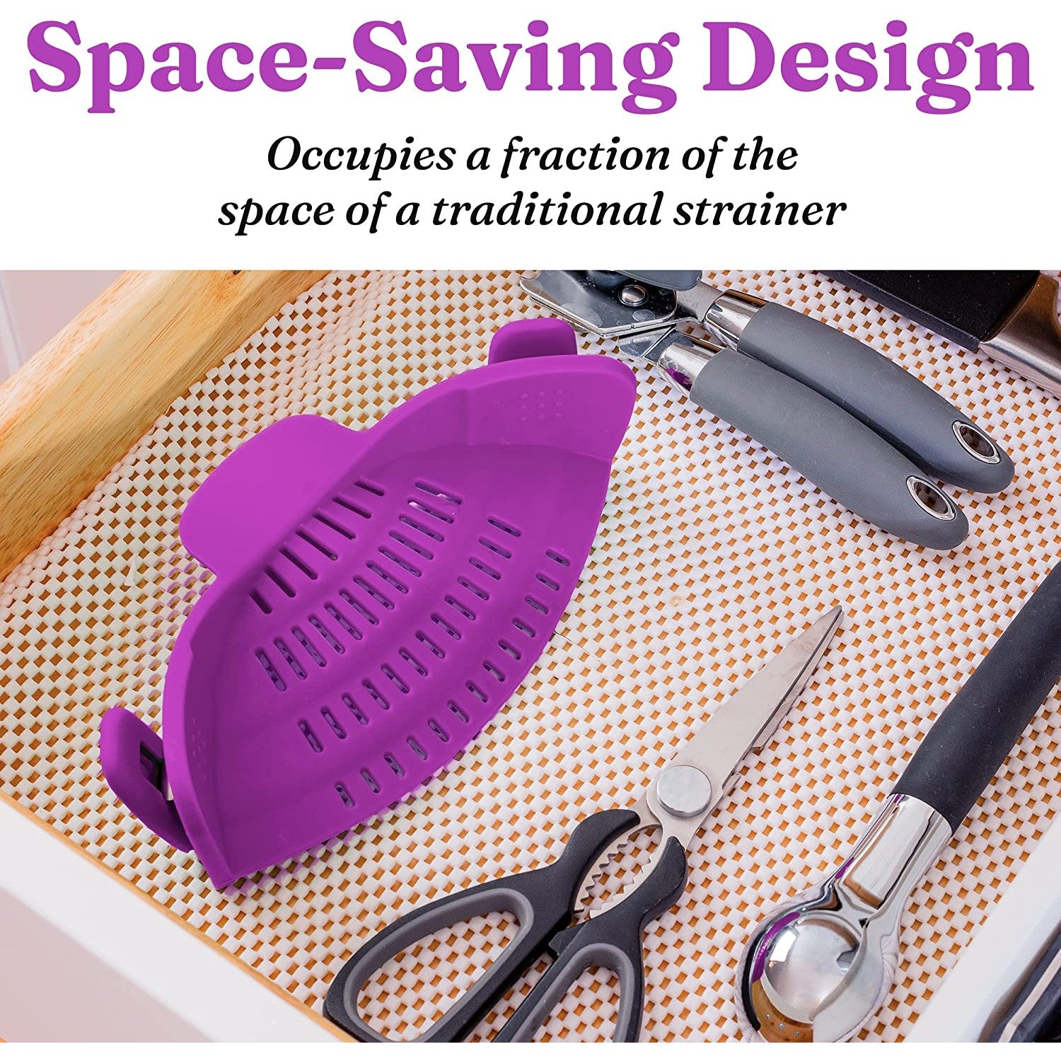 A purple colored silicone pasta strainer folded up in a kitchen drawer next to other kitchen accessories. The text reads, 'Space-saving design. Occupies a fraction of the space of a traditional strainer.'
