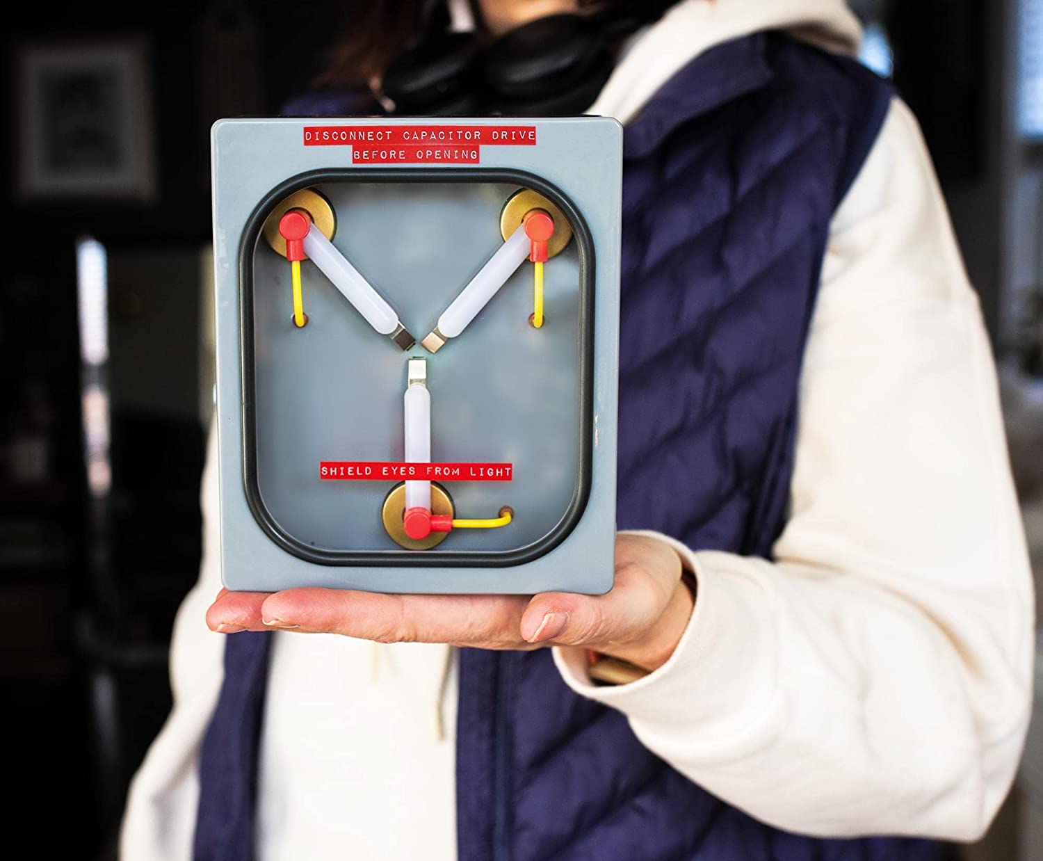 A person has in the palm of their hand a Back to the Future Flux Capacitor replica mood light