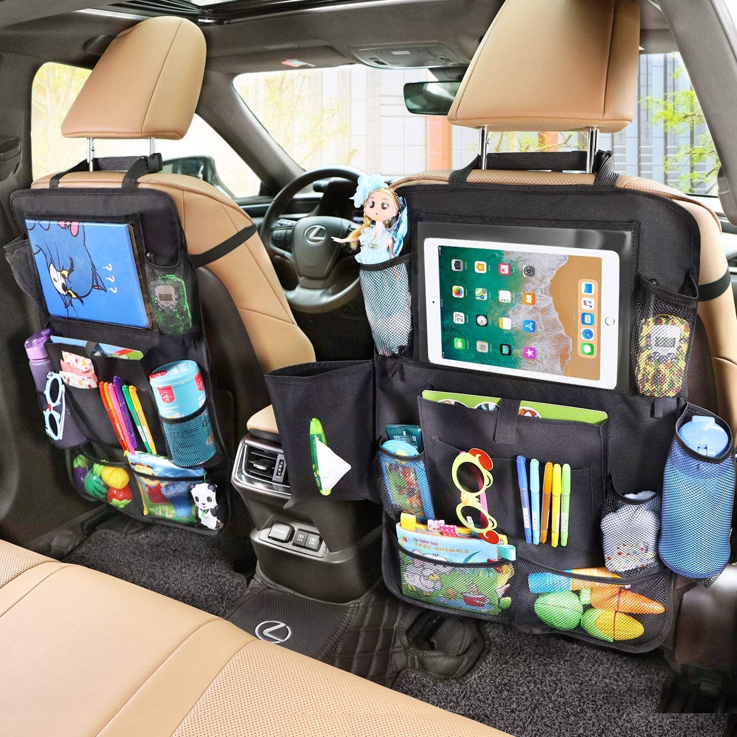 Two black backseat car storage organizers are strapped to the front seats of a car. The two organizers are filled with items.