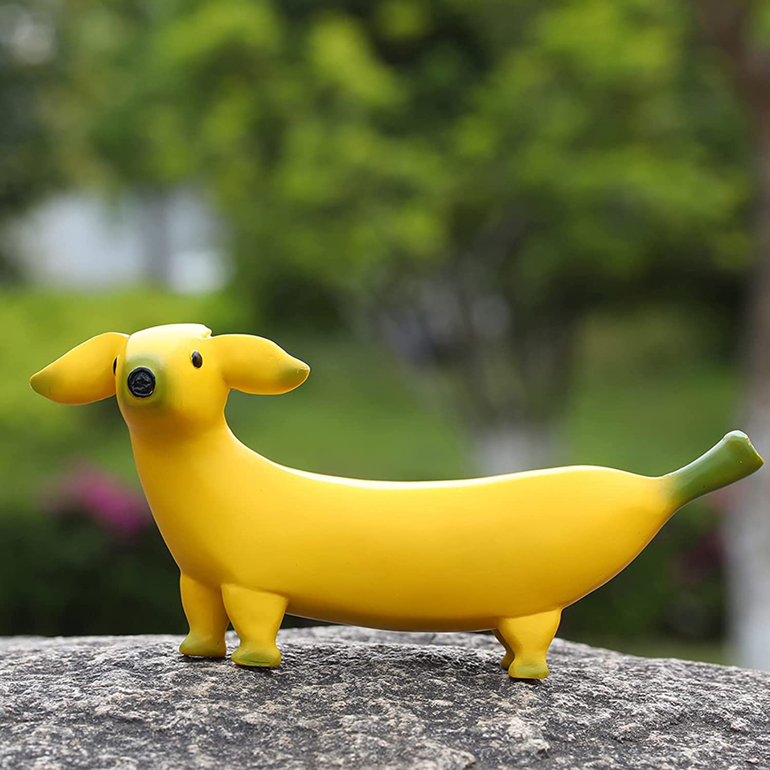 A garden ornament which is called a banana dog as it is shaped like a banana but with a dogs head.