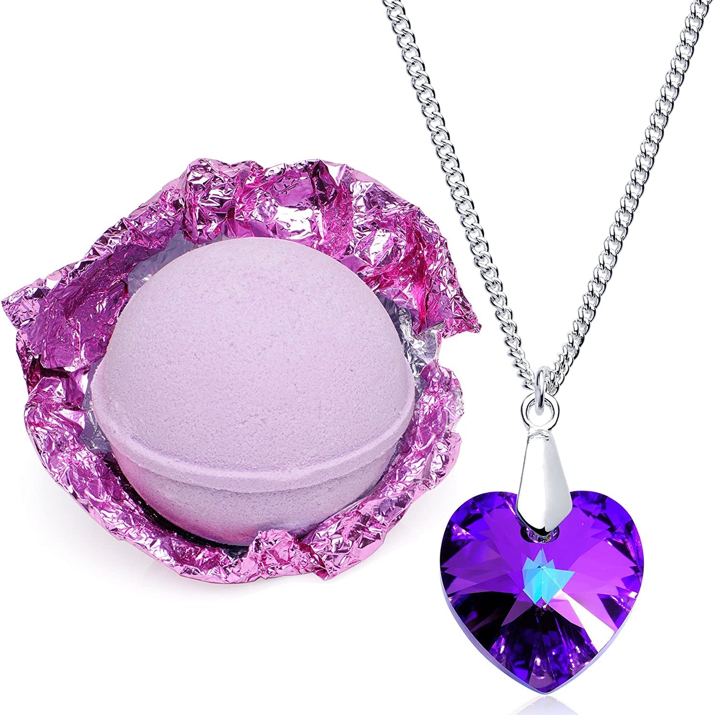 A half unwrapped purple lavender bath bomb with a heart shaped necklace next to it.