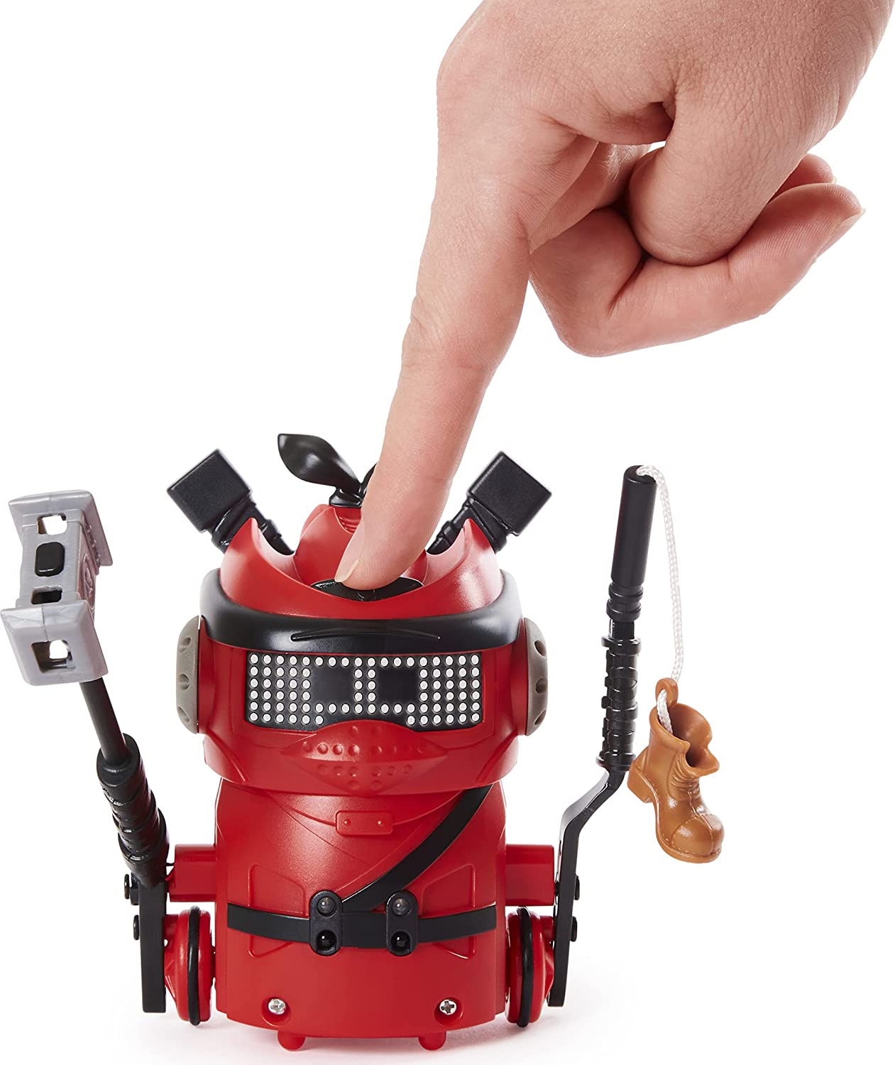 A finger is pressing down on a red Ninja Bot to show the soft material the robot is made of.