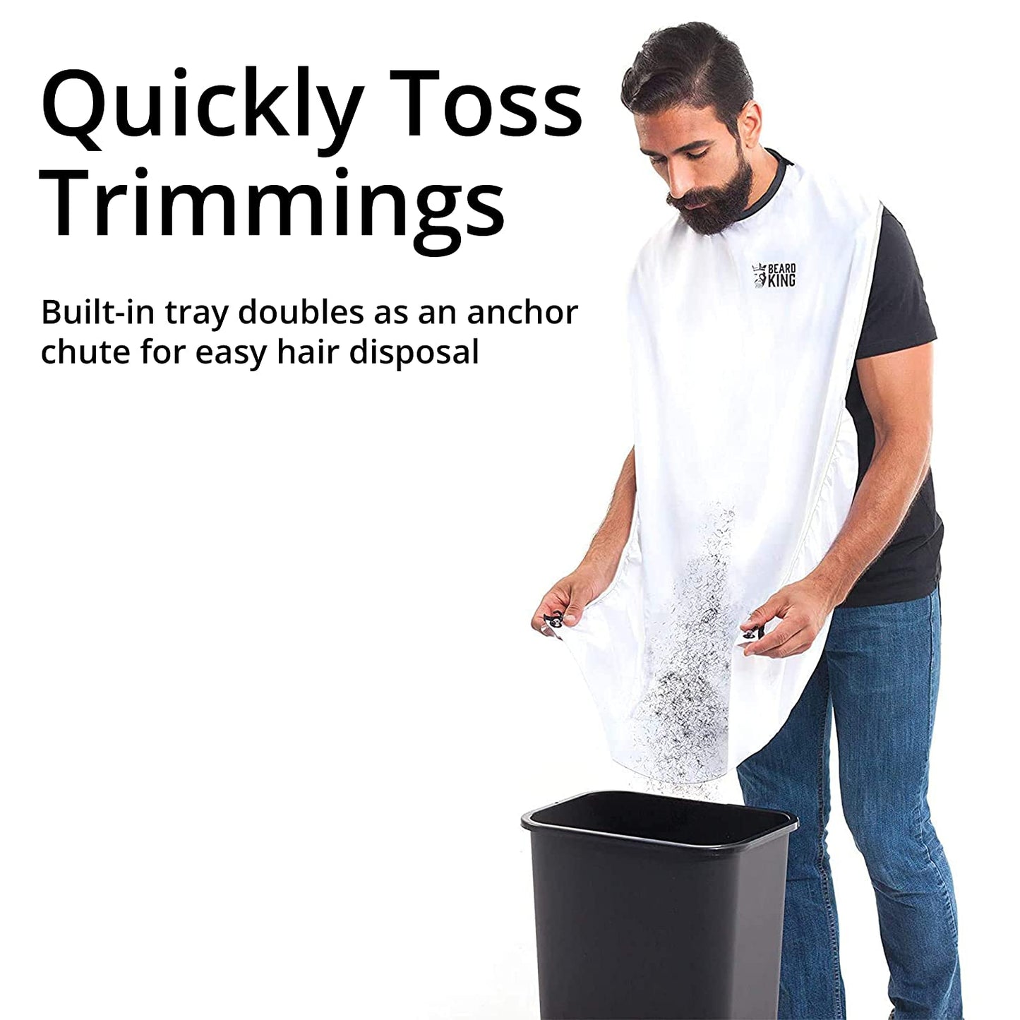 A man is tossing beard clippings into a trash can from his beard bib apron. The text reads, 'Quickly toss trimmings. Built-in tray doubles as an anchor chute for easy hair disposal.'