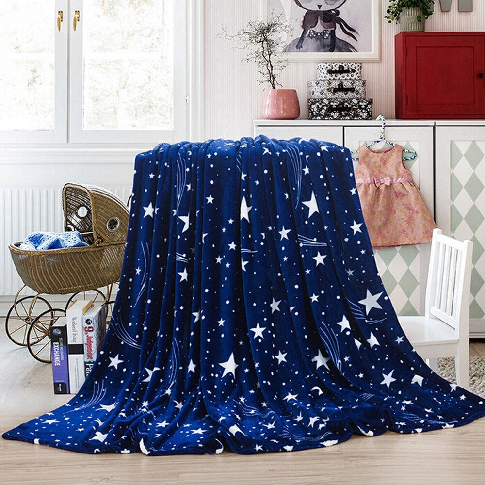 A dark royal blue blanket covered in different sized stars draped over a chair.