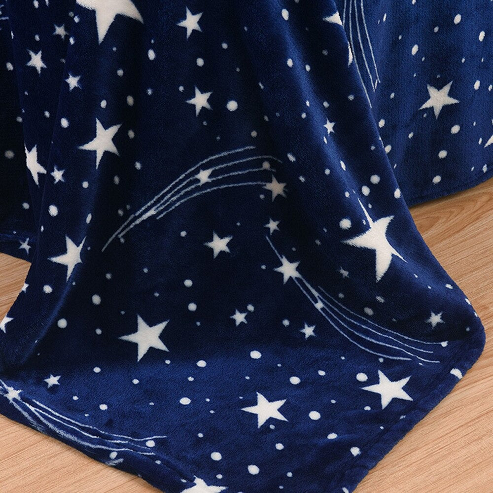 A close up view of a blue fleece blanket covered in white stars.